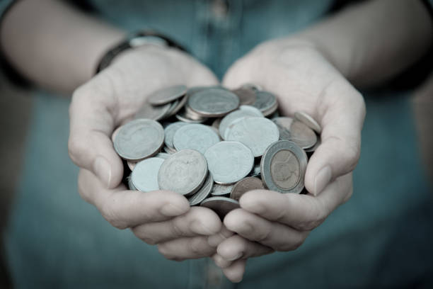 A coins in people hands in saving money concept stock photo