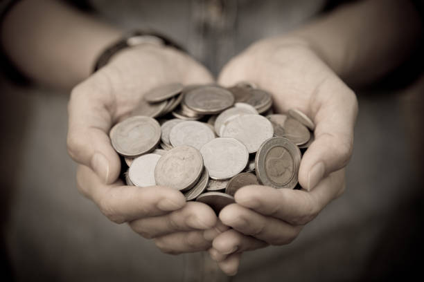 A coins in people hands in saving money concept stock photo