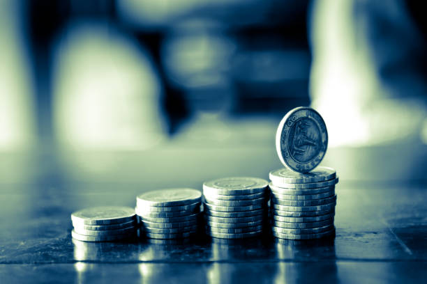 row of coins in banking and finance concept stock photo