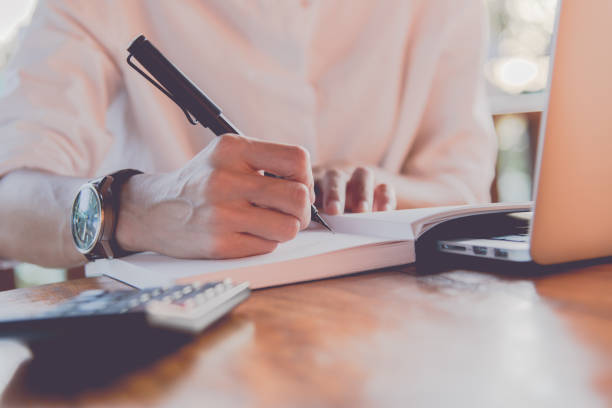 istock Close up women hand on writng on notebook and work with calculator 1017528900