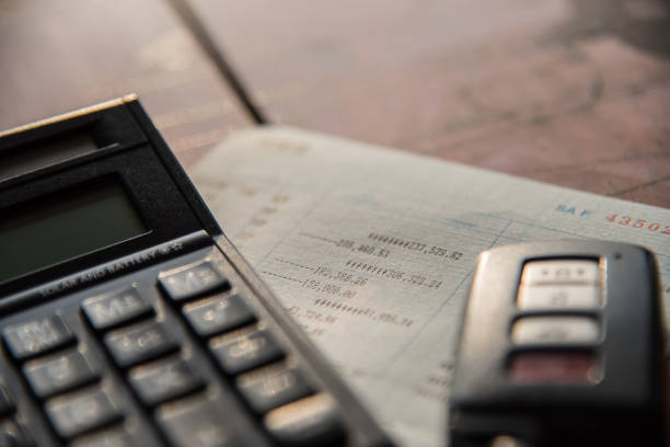 close up of calculator ,car remote and account book in finance and banking concept stock photo