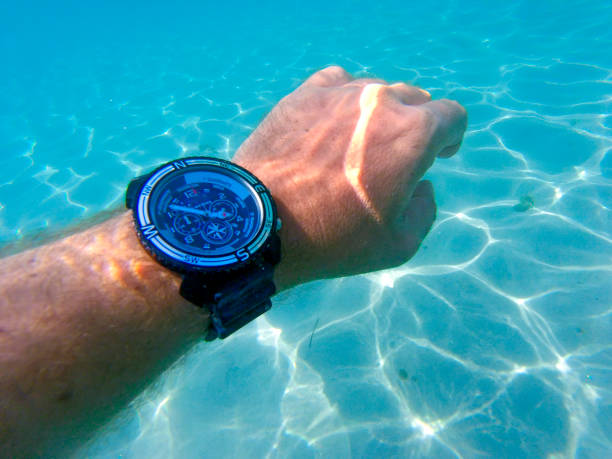 istock Hand with watch under the sea 1017550912