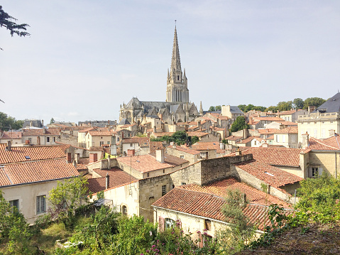 A cityscape photograph of the town of Fontenay Le Comte in the region of Vendée, France, showing red tiled roofs