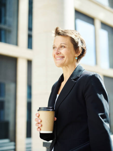 istock Cheerful businesswoman holding coffee cup 1017556984