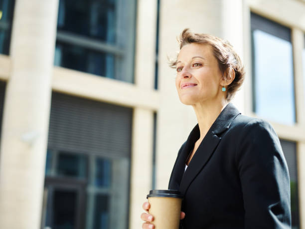 istock Smiling executive woman with coffee 1017556990