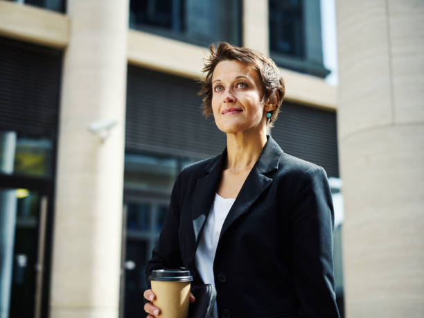istock Content businesswoman in suit outside 1017556996