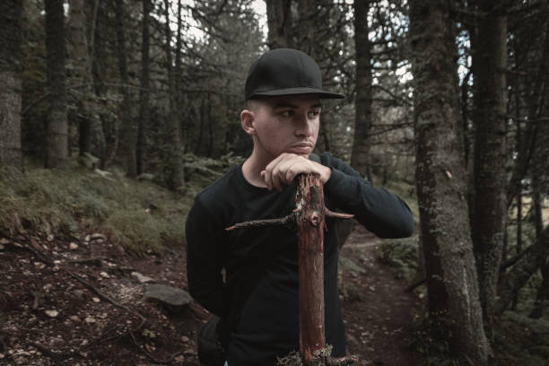 istock curious hiker hold wood stick in front of forest 1017569454