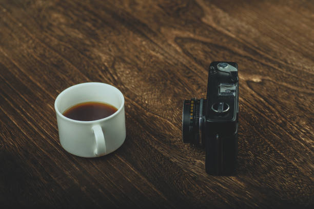 istock Retro camera and a coffee on wood board 1017569614