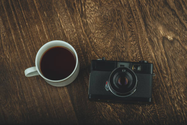 istock Retro camera and a coffee on wood board 1017574092
