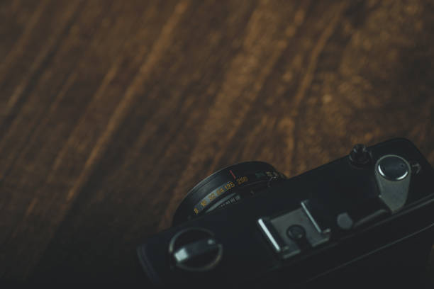 istock Retro camera on wood board 1017574386