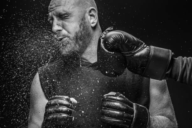 MMA fighter boxing knockout Bearded Aggressive Adult Man MMA fighter being knocked out black and white men facial hair beard stock pictures, royalty-free photos & images