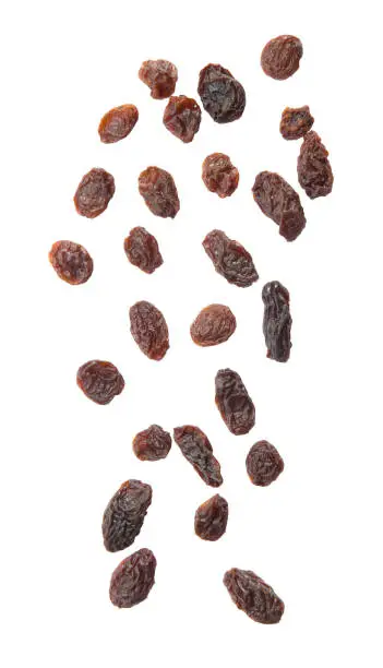Photo of Raisins falling isolated on white background