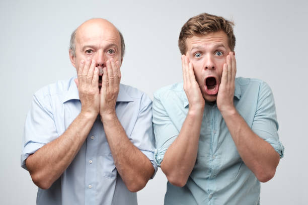istock Frightened two men have scared expressions, look nervously, isolated over white background. 1017599514