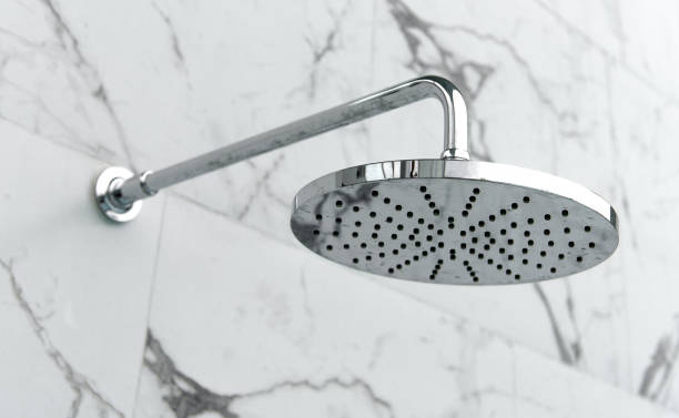 istock close up on head shower in bathroom. 1017602048