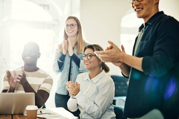 istock Diverse group of smiling colleagues clapping during an office meeting 1017602856