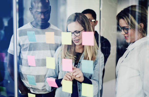 istock Diverse colleagues brainstorming with sticky notes in an office 1017602860