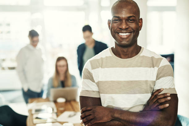 istock Young African designer smiling confidently while standing in an office 1017602902
