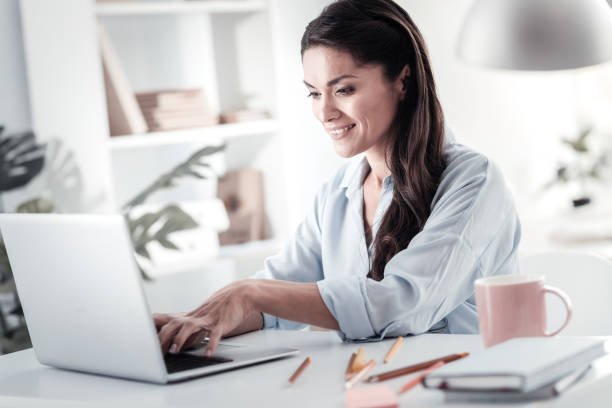 istock Joyful brunette woman typing message 1017608150
