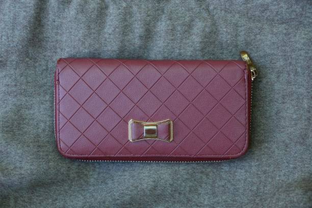 istock large red leather purse on gray fabric 1017617322