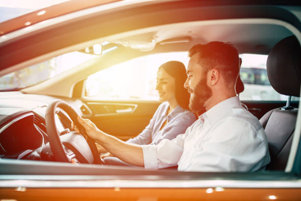 istock Young beautiful happy couple ride in car while travelling 1017620346