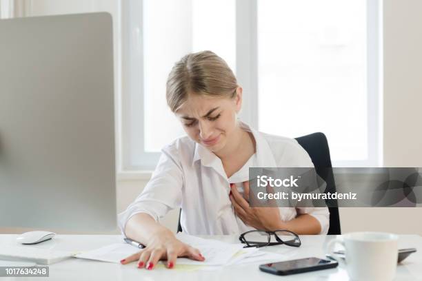 Young Businesswoman Touching Her Chest Stock Photo - Download Image Now - Heart Attack, Women, One Woman Only
