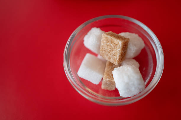 Brown and white sugar in a small glass bowl