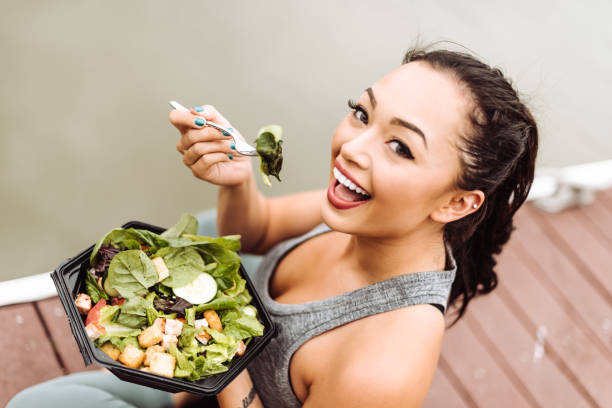 istock fitness woman eating a salad 1017636728