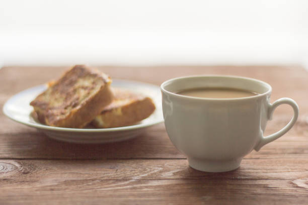 istock rustic Breakfast, coffee with milk and fried pieces of bread in the egg 1017639290