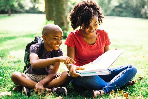 istock sister doing the homework with the little brother 1017641492