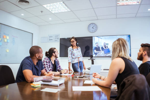 istock colleagues discussing during video conference in meeting room 1017644408