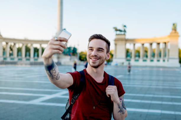 istock Young guy taking selfie in Budapest at Hero's Square 1017647180