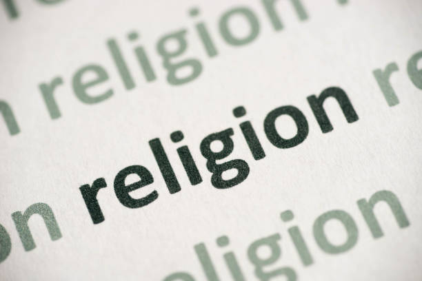 istock word  religion printed on paper macro 1017647634