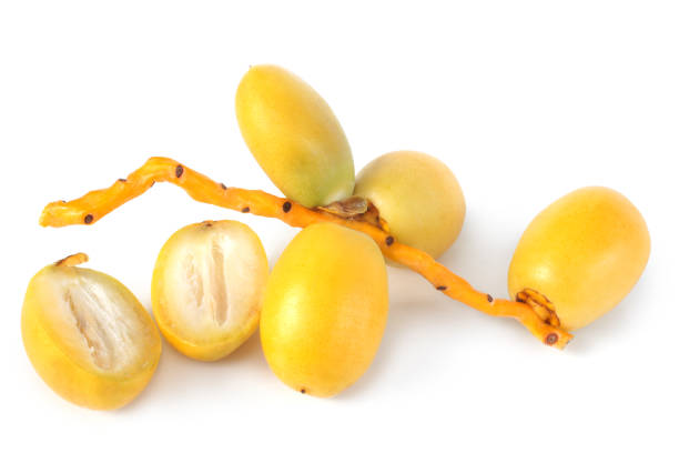 Bunch of yellow raw dates on white background