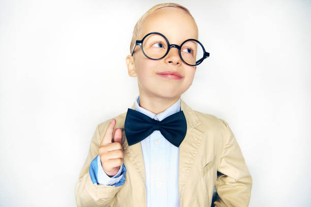 cheerful boy in suit holding finger up - child prodigy imagens e fotografias de stock