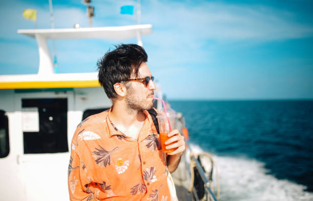 istock Young man relaxing on the boat while traveling in between Thai islands 1017664034