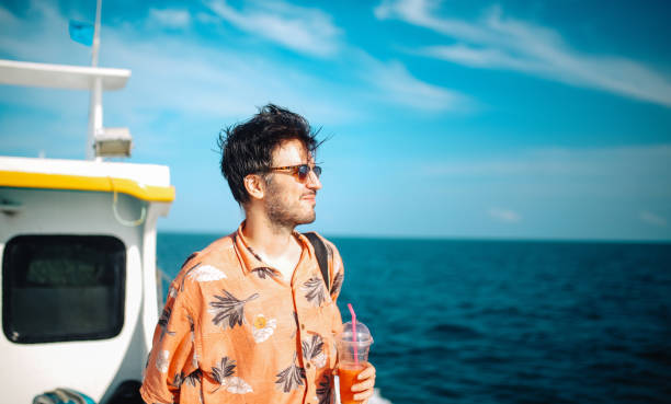 istock Young man relaxing on the boat while traveling in between Thai islands 1017666862