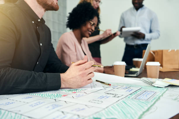 istock Diverse group of designers working with blueprints in an office 1017676140