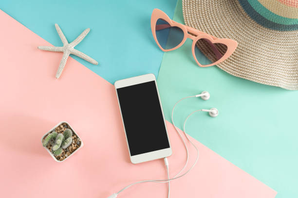 istock Women's accessories items with smart phone on pastel colors background 1017680388