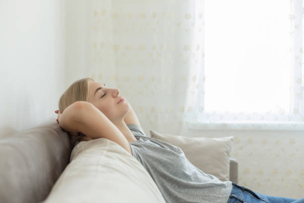 Young woman relaxing on a sofa at home