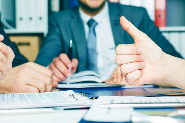 istock Business team networking concept - office table with many printed professional paper charts and hands of young people discussing and gesturing 1017685546