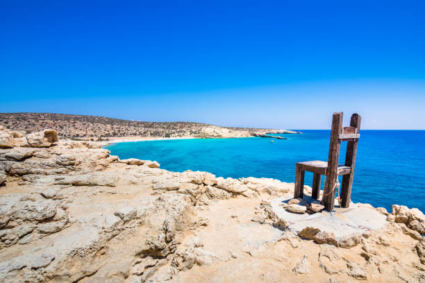 The tropical beach of Tripiti at the southern point of Gavdos island and Europe too, with the famous giant wooden chair, Greece. The tropical beach of Tripiti at the southern point of Gavdos island and Europe too, with the famous giant wooden chair, Greece. juniperus chinensis stock pictures, royalty-free photos & images
