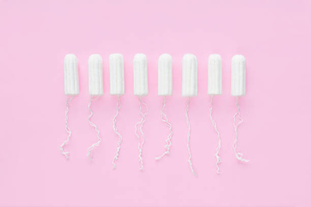 Menstrual period concept. Woman hygiene protection. Cotton tampons on pink background. Top view, flat lay. Menstrual period concept. Woman hygiene protection. Cotton tampons on pink background. Top view, flat lay. Ovulation stock pictures, royalty-free photos & images