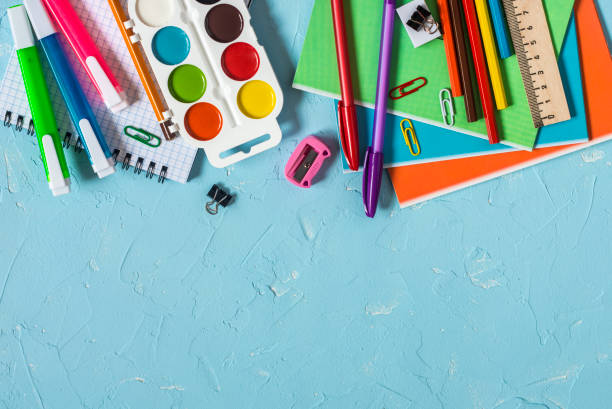 istock Back to school. School accessories - notebooks, pens, pencils, paint on a blue background, top view. Education concept. Flat lay, copy space 1017688906