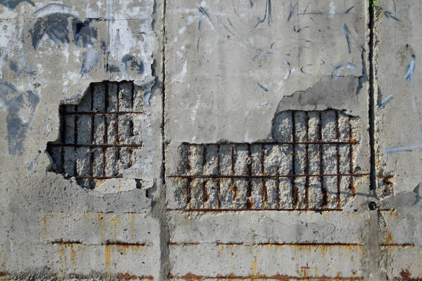 Destroying wall of reinforced concrete. falling off plaster