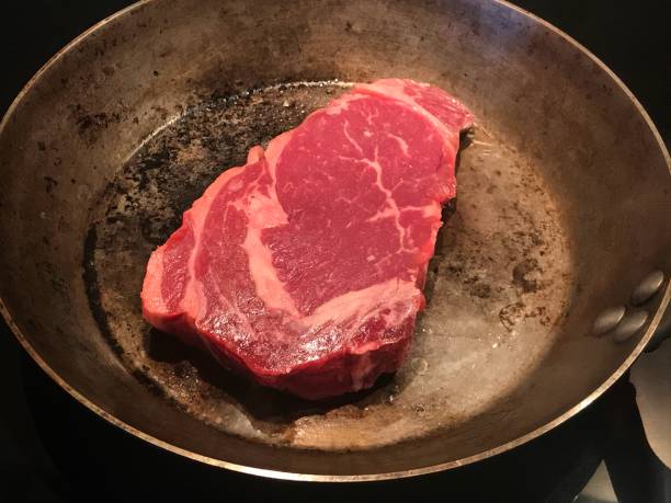 istock Rib eye steak cooking in cast iron pan 1017703492