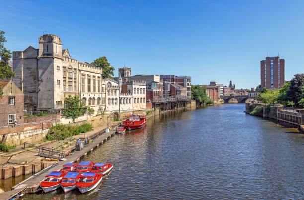 The River Ouse and Guildhall on a sunny afternoon. The River Ouse and the Guidhall on a sunny afternoon.  Small boats are in the foreground and the Ouse Bridge can be seen in the distance. ouse river photos stock pictures, royalty-free photos & images
