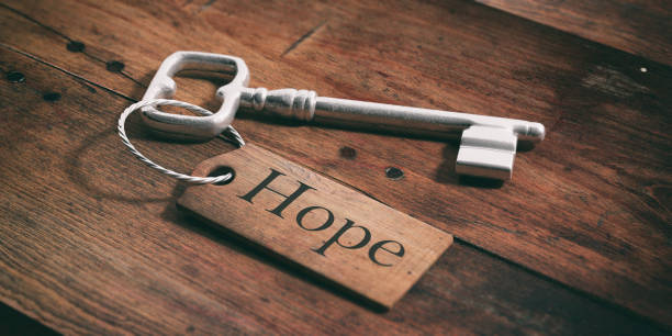 istock Old key with tag hope on a wooden background. 3d illustration 1017718880