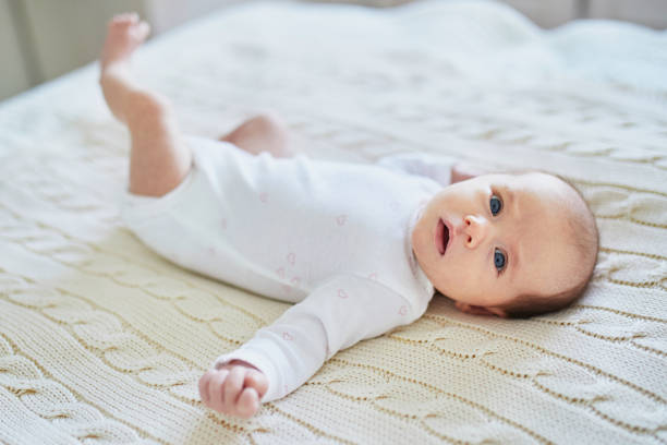 istock Baby girl lying on bed in nursery 1017718882