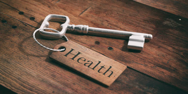 Old metal key with label health on a wooden background. 3d illustration
