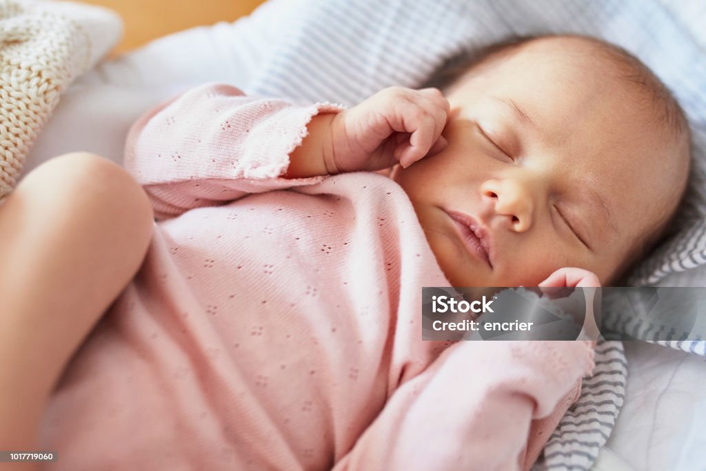 Newborn baby sleeping Newborn baby girl sleeping peacefully in the crib Baby Girls Stock Photo